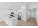 Bright kitchen with white cabinets, stainless steel appliances and a view to the home entrance at 5790 Crystal Beach Rd, Winter Haven, FL 33880