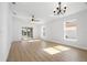 Bright, open living room with wood-look floors and sliding doors to a screened lanai at 5790 Crystal Beach Rd, Winter Haven, FL 33880