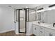 Modern main bathroom with a tiled shower stall featuring a glass door and a double sink vanity at 5790 Crystal Beach Rd, Winter Haven, FL 33880