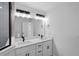 Well-lit bathroom featuring a double sink vanity with sleek fixtures and a frameless mirror at 5790 Crystal Beach Rd, Winter Haven, FL 33880