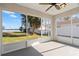 Screened-in porch with picturesque water views, palm trees, and lush green landscape at 5790 Crystal Beach Rd, Winter Haven, FL 33880