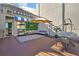 Spacious rooftop deck featuring outdoor seating, a green wall with white lettering, and an umbrella at 6165 Carrier Dr # 3512, Orlando, FL 32819