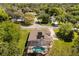 Aerial view of the property showcasing the screened pool, solar panels, and well-maintained landscaping at 6651 Sylvan Woods Dr, Sanford, FL 32771