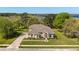 Aerial view of a peach colored single Gathering home with mature landscaping, lake view, and large lot at 6651 Sylvan Woods Dr, Sanford, FL 32771