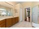 Well-lit bathroom featuring a vanity, sink, tile floors, and a glass-enclosed shower at 6651 Sylvan Woods Dr, Sanford, FL 32771