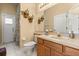 Bright bathroom with a sink, toilet, shower with plants, and a mirror at 6651 Sylvan Woods Dr, Sanford, FL 32771