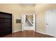 Bedroom features hardwood floors and a view of the stairway through the open doorway at 6651 Sylvan Woods Dr, Sanford, FL 32771