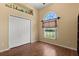 Bedroom with closet, window, light wood floors, and yellow walls at 6651 Sylvan Woods Dr, Sanford, FL 32771