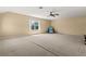 Bonus room featuring carpet, ceiling fan, one window, and blue armchair at 6651 Sylvan Woods Dr, Sanford, FL 32771