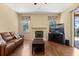 Cozy living room featuring a fireplace, wood floors, and plenty of natural light at 6651 Sylvan Woods Dr, Sanford, FL 32771