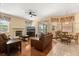 Inviting living room with wood floors, fireplace, ceiling fan, and dining nook at 6651 Sylvan Woods Dr, Sanford, FL 32771