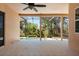 The screened patio overlooks the pool, lush greenery, and an expansive backyard at 6651 Sylvan Woods Dr, Sanford, FL 32771