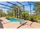 A screened-in pool with lush greenery, and a pool house with plenty of space for entertaining at 6651 Sylvan Woods Dr, Sanford, FL 32771