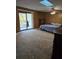 Bedroom featuring a slider, skylight, and wood paneling at 7438 Vivian Ln, Orlando, FL 32818