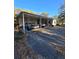 Spacious carport featuring two parked cars and ample space for additional storage and parking at 7438 Vivian Ln, Orlando, FL 32818