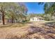 Wide shot of single-story home with a storage building and large yard at 7438 Vivian Ln, Orlando, FL 32818