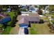 Single-story home with a driveway, a large front and back yard with neighborhood pool in the background at 7717 Pineapple Dr, Orlando, FL 32835