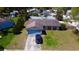 Single-story home with a driveway, a large front and back yard and blue garage door at 7717 Pineapple Dr, Orlando, FL 32835