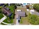 An aerial view shows a single-Gathering home with a driveway and a well-maintained lawn at 7717 Pineapple Dr, Orlando, FL 32835