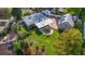 Aerial shot of a home with a well-manicured lawn, canopy, brick driveway, and a detached garage at 801 Silver Dr, Orlando, FL 32804