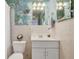 Cozy bathroom featuring floral wallpaper and ample lighting at 801 Silver Dr, Orlando, FL 32804