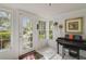 Bright entryway featuring a tiled floor, glass-paneled door, and a piano, with natural light streaming through the windows at 801 Silver Dr, Orlando, FL 32804