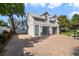 Two-car garage with glass doors and a brick paved driveway at 801 Silver Dr, Orlando, FL 32804