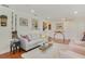 Cozy living room with hardwood floors, a gray sofa, and eclectic decor, enhanced by natural light at 801 Silver Dr, Orlando, FL 32804