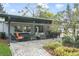 Covered outdoor patio with plenty of seating, landscaping and brick pavers at 801 Silver Dr, Orlando, FL 32804