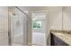 Bathroom featuring a glass shower, granite countertop, and dark wood vanity at 8544 Magnificent Ln, Groveland, FL 34736