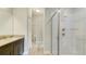 Bathroom featuring a glass shower, granite countertop, and dark wood vanity at 8544 Magnificent Ln, Groveland, FL 34736