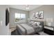 Serene bedroom featuring a large window, plush bedding, and tasteful decor for a relaxing retreat at 8544 Magnificent Ln, Groveland, FL 34736