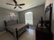 Bedroom features include a dark metal bed frame, tile floors, a ceiling fan, and natural light from the window at 938 Cherry Valley Way, Orlando, FL 32828