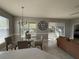 Charming dining area with a glass table, chandelier, and natural light, perfect for Gathering meals at 938 Cherry Valley Way, Orlando, FL 32828