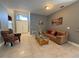 Inviting living room with tile flooring and comfortable seating, perfect for relaxation and entertaining at 938 Cherry Valley Way, Orlando, FL 32828