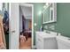 A full bathroom with a green painted wall, a vanity with a sink, and a toilet at 941 Grey Oak Ct, Orlando, FL 32809