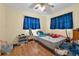 A cozy bedroom with yellow walls, hardwood floors and natural light creating a relaxing space at 941 Grey Oak Ct, Orlando, FL 32809