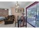 Dining area showcasing a chandelier and connection to the bright backyard at 941 Grey Oak Ct, Orlando, FL 32809