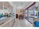 Bright kitchen with blue countertops, leads to dining area with backyard view at 941 Grey Oak Ct, Orlando, FL 32809