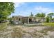 Backyard view of the single-story house showcasing the screened porch and laundry area at 941 Grey Oak Ct, Orlando, FL 32809