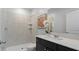 Modern bathroom with tile shower, black vanity, white countertop, and decorative floral arrangement at 101 Kayak Ave, Haines City, FL 33844