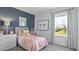 Charming bedroom with accent wall, stylish decor, and bright natural light at 101 Kayak Ave, Haines City, FL 33844