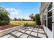 Concrete block back patio featuring stone accents and views of green open space at 1234 Villa Ln # S, Apopka, FL 32712