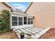 Back patio featuring a small Florida room addition, stone accents, and some landscaping at 1234 Villa Ln # S, Apopka, FL 32712