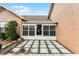 A view of the back patio featuring a Florida room addition and stone accents at 1234 Villa Ln # S, Apopka, FL 32712