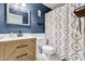 Stylish bathroom featuring a vanity with black hardware, a patterned shower curtain, and a blue painted wall at 1234 Villa Ln # S, Apopka, FL 32712