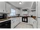 Well-organized kitchen with a tile floor, butcher block counters, white cabinets, and modern appliances at 1234 Villa Ln # S, Apopka, FL 32712