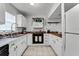 Well-lit kitchen featuring a stainless steel sink, white cabinetry, butcher block counters, and tile flooring at 1234 Villa Ln # S, Apopka, FL 32712