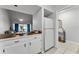 Bright kitchen area with butcher block counters, white cabinets, and an open flow to an adjacent sitting room at 1234 Villa Ln # S, Apopka, FL 32712