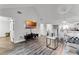 Bright living room featuring a vaulted ceiling, wood floors, modern decor, and seamless flow to the adjacent kitchen at 1234 Villa Ln # S, Apopka, FL 32712